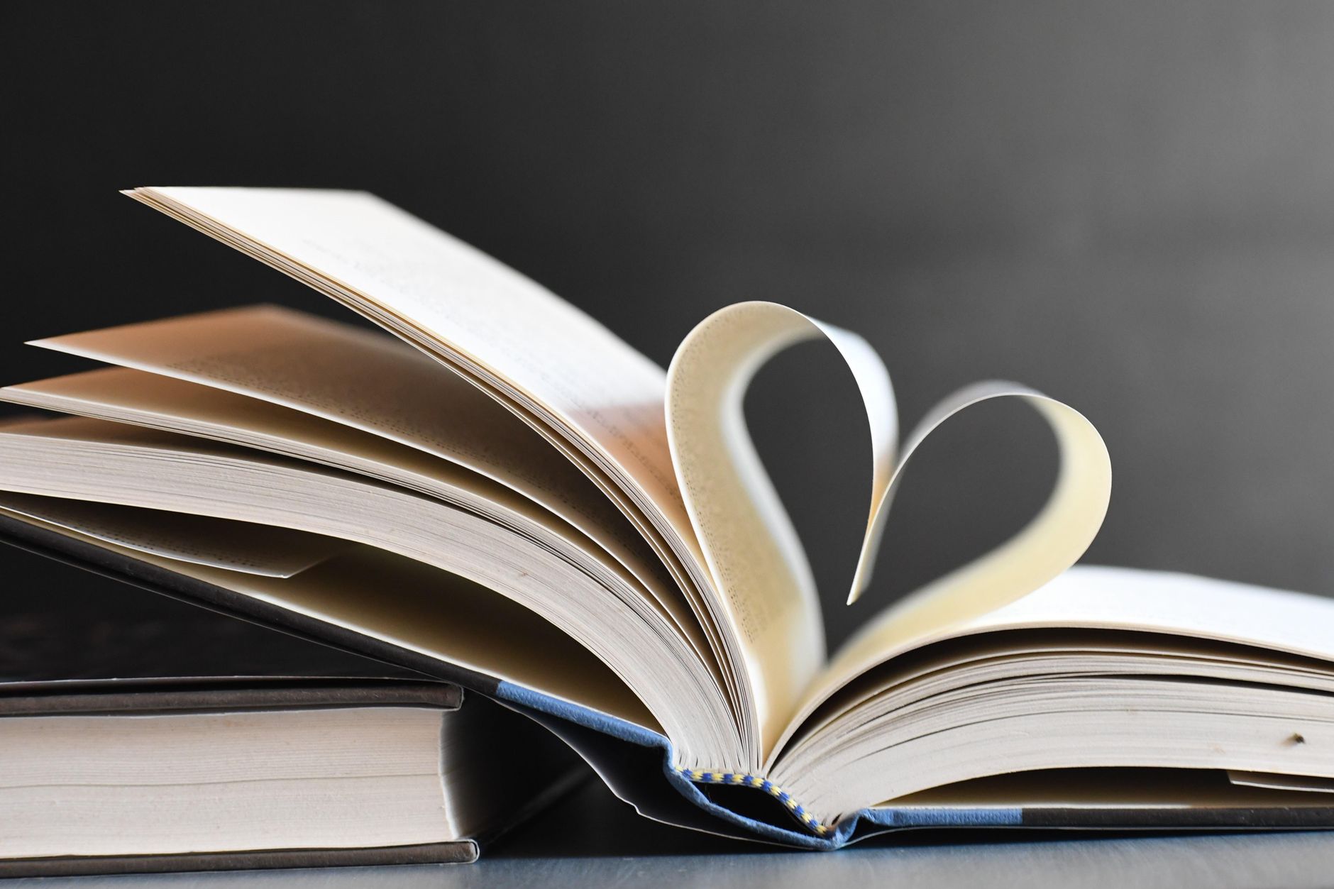 open book with heart shaped pages in focus